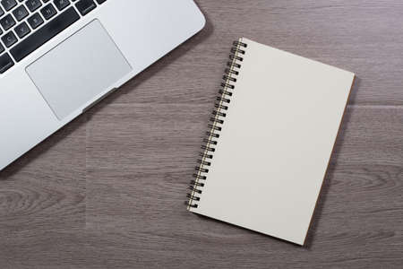 Wood office desk table top view with laptop and supplies.の写真素材