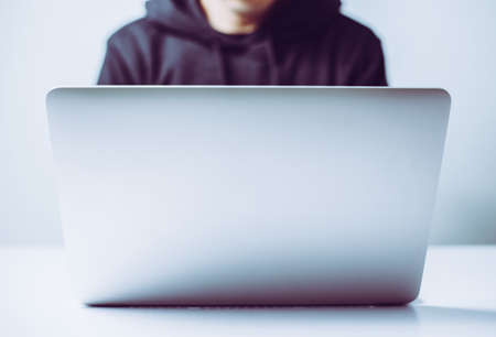 Hacker in front of the laptop computer.の写真素材