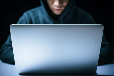 Hacker in front of the laptop computer.の写真素材