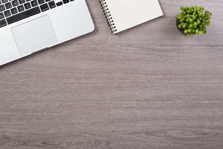 Wood office desk table top view with laptop and supplies.の写真素材