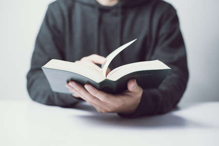 Man or woman is reading the holy bible on the table.の写真素材