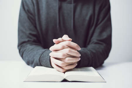 Man is praying on the white table.の写真素材