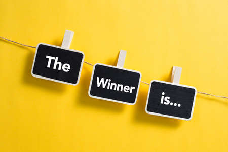 The Winner is concept small blackboard hanging on line.の写真素材
