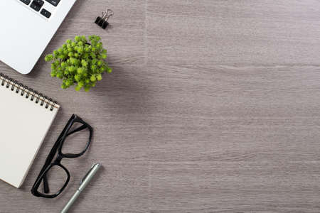 Wood office desk table top view with laptop and supplies.の写真素材
