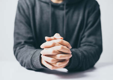 Man is praying on the white table.の写真素材