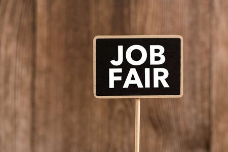 Job Fair text on blackboard sign board against wooden background.の写真素材