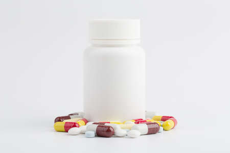 Assorted pharmaceutical medicine pills, tablets and capsules over white background.の写真素材