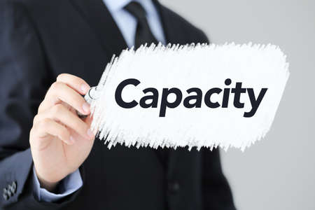 Businessman is writing Capacity concept text on the screen.の写真素材