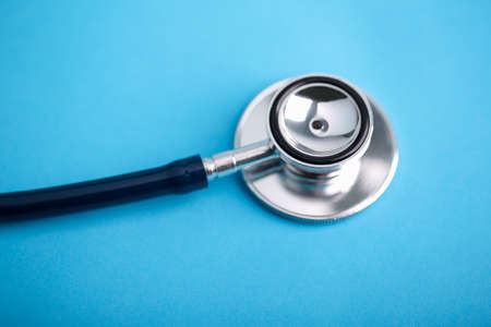Stethoscope closeup shot on the blue background.の写真素材