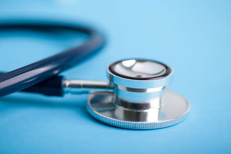 Stethoscope closeup shot on the blue background.の写真素材