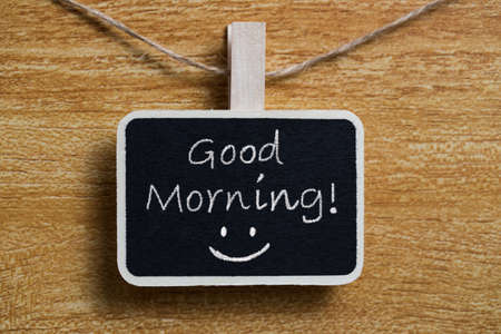 Good Morning blackboard sign against wooden background.の写真素材