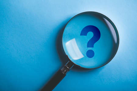 Magnifying With Question Mark is isolated on the blue background.の写真素材
