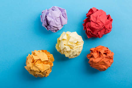 Crumpled paper balls up piece of paper on blue background.の写真素材