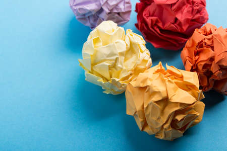 Crumpled paper balls up piece of paper on blue background.の写真素材
