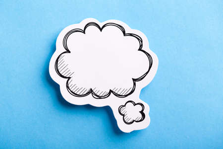 Blank white speech bubble isolated on blue background.の写真素材