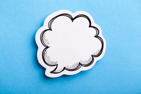 Blank white speech bubble isolated on blue background.の写真素材