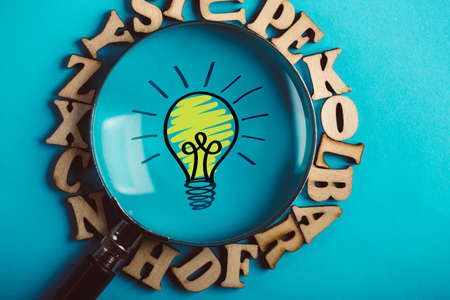 Creative Idea And Innovation Concept with magnifying on blue background.