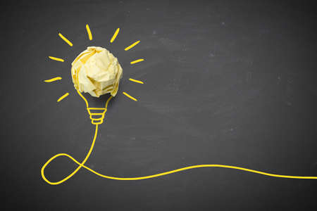 Inspiration concept crumpled paper light bulb metaphor for good idea.の写真素材