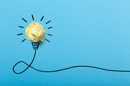 Creative idea, Inspiration, New idea and Innovation concept with Crumpled Paper light bulb on blue background.の写真素材