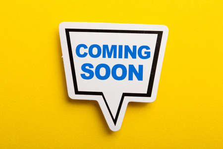 Coming Soon speech bubble isolated on the yellow background.の写真素材