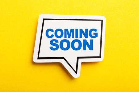 Coming Soon speech bubble isolated on the yellow background.の写真素材