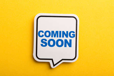 Coming Soon speech bubble isolated on the yellow background.の写真素材