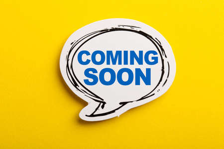 Coming Soon speech bubble isolated on the yellow background.の写真素材