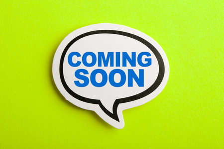 Coming Soon speech bubble isolated on the yellow background.の写真素材