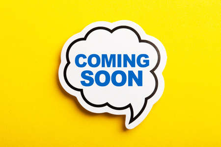 Coming Soon speech bubble isolated on the yellow background.の写真素材