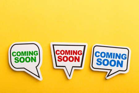 Coming Soon speech bubble isolated on the yellow background.の写真素材