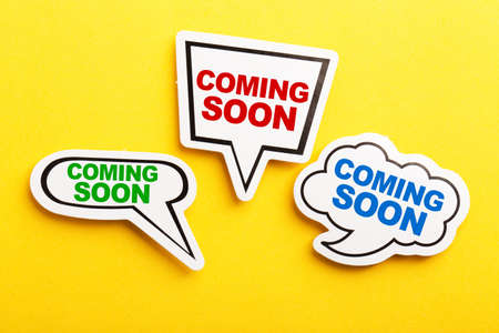Coming Soon speech bubble isolated on the yellow background.の写真素材
