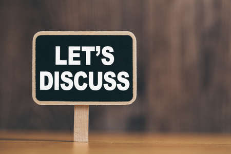 Conceptual chalkboard showing white text let us discuss.の写真素材