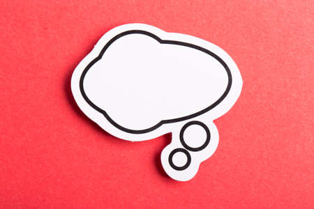 Blank white speech bubble isolated on red background.の写真素材