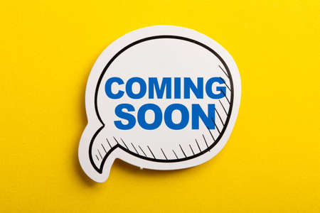 Coming Soon speech bubble isolated on the yellow background.の写真素材