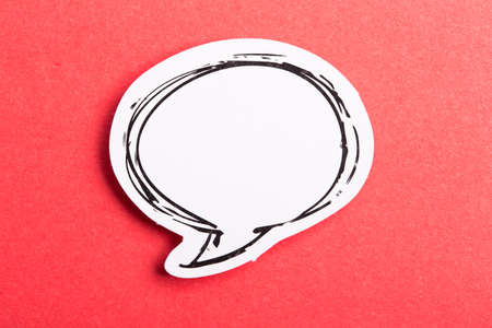 Blank white speech bubble isolated on red background.の写真素材