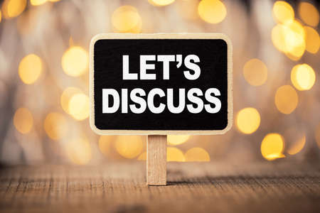 Conceptual chalkboard showing white text let us discuss.の写真素材