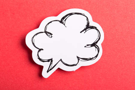 Blank white speech bubble isolated on red background.の写真素材