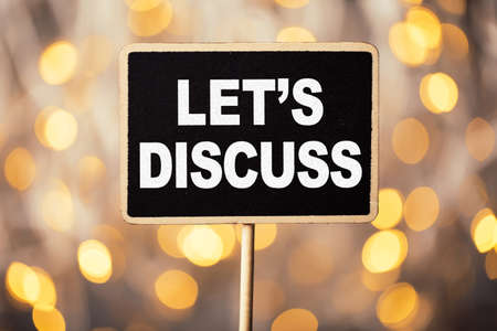 Conceptual chalkboard showing white text let us discuss.の写真素材