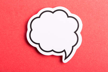 Blank white speech bubble isolated on red background.の写真素材