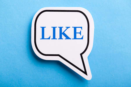 Like text speech bubble isolated on blue background.の写真素材
