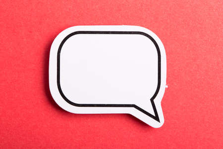 Blank white speech bubble isolated on red background.の写真素材