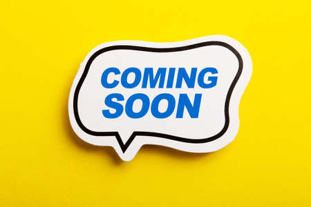Coming Soon speech bubble isolated on the yellow background.の写真素材