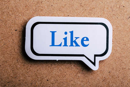 Like Concept speech bubble isolated on brown paper background with shadow.の写真素材