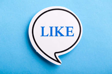 Like text speech bubble isolated on blue background.の写真素材