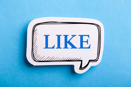 Like text speech bubble isolated on blue background.の写真素材