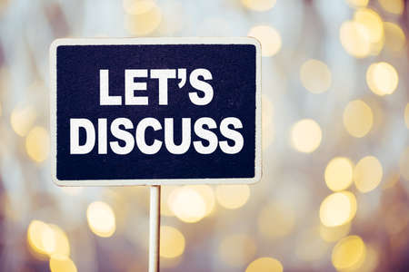 Conceptual chalkboard showing white text let us discuss.の写真素材