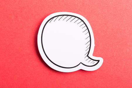 Blank white speech bubble isolated on red background.の写真素材