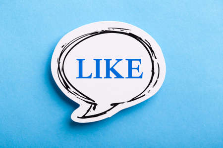 Like text speech bubble isolated on blue background.の写真素材