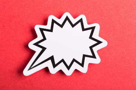 Blank white speech bubble isolated on red background.の写真素材