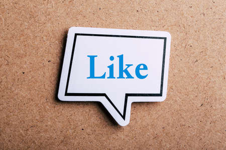 Like Concept speech bubble isolated on brown paper background with shadow.の写真素材